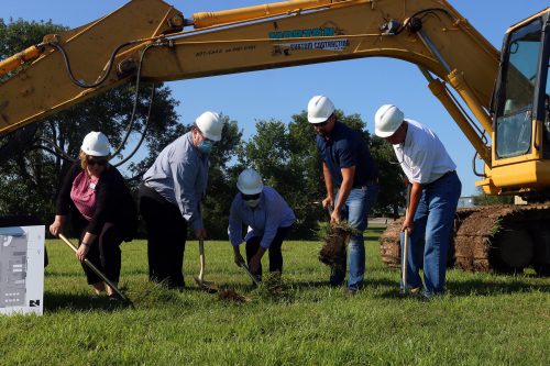 5 adults breaking ground