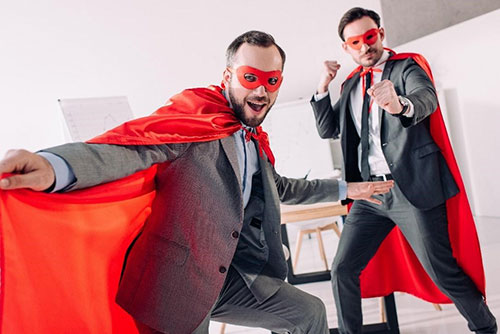 Corporate giving - Two business men in super hero costumes